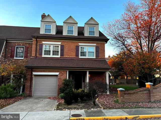 a front view of house with yard space and trees