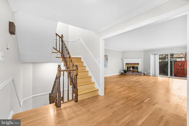 a large kitchen with a lot of counter space and wooden floor