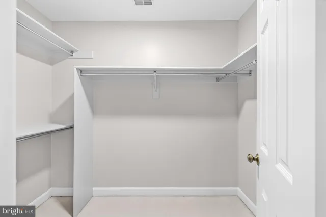 a view of empty room with wooden floor and fireplace