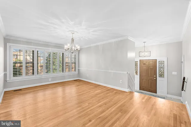 a view of empty room with wooden floor and fireplace