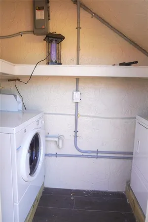 a view of storage and utility room with washer and dryer