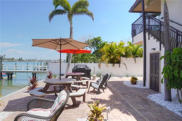 a patio with a patio table and chairs