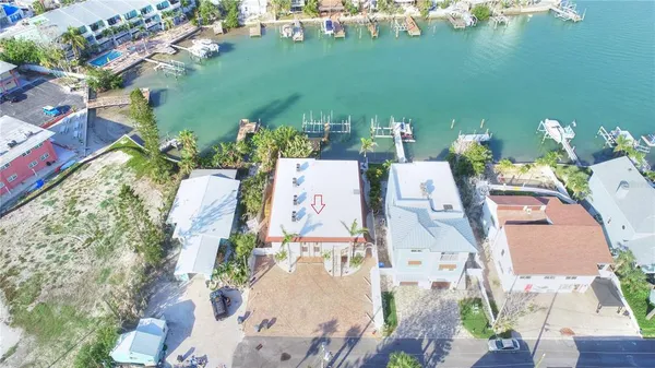 an aerial view of a house with outdoor space and lake view