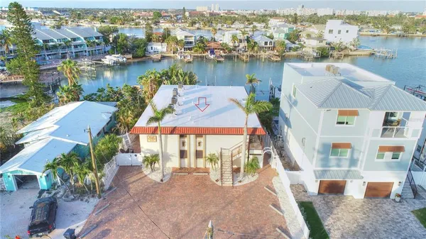 an aerial view of residential houses with outdoor space and lake view