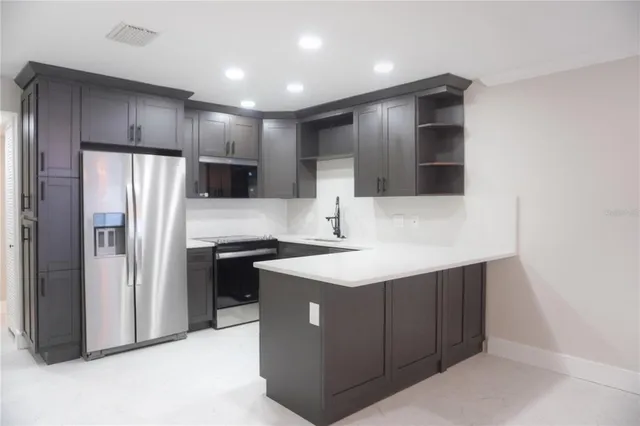 a kitchen with stainless steel appliances a refrigerator and a sink