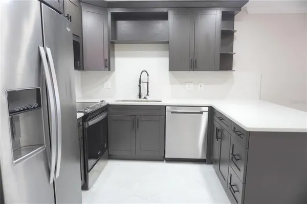 a kitchen with stainless steel appliances a refrigerator and a sink