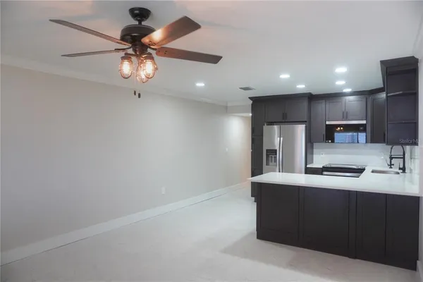 a kitchen with stainless steel appliances a sink and a refrigerator