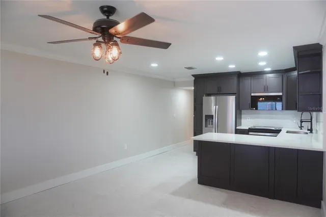 a kitchen with stainless steel appliances a sink and a refrigerator