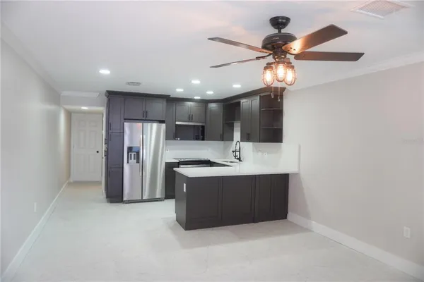 a view of a kitchen with a sink and stainless steel appliances