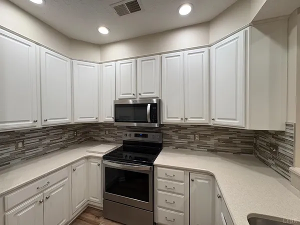a view of wooden floor and a chandelier in a room