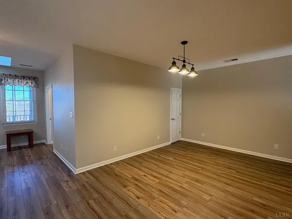 a view of a room with wooden floor