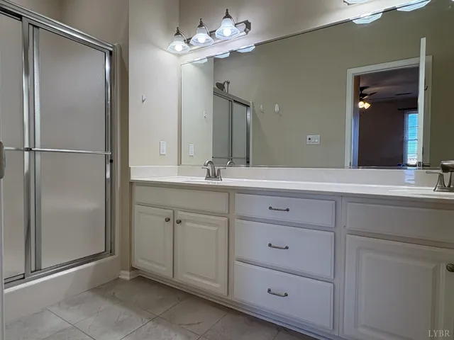 a bathroom with a double vanity sink and a mirror