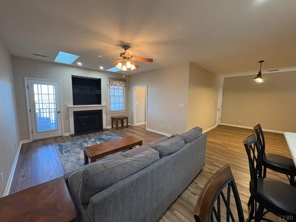 a living room with furniture fireplace and flat screen tv