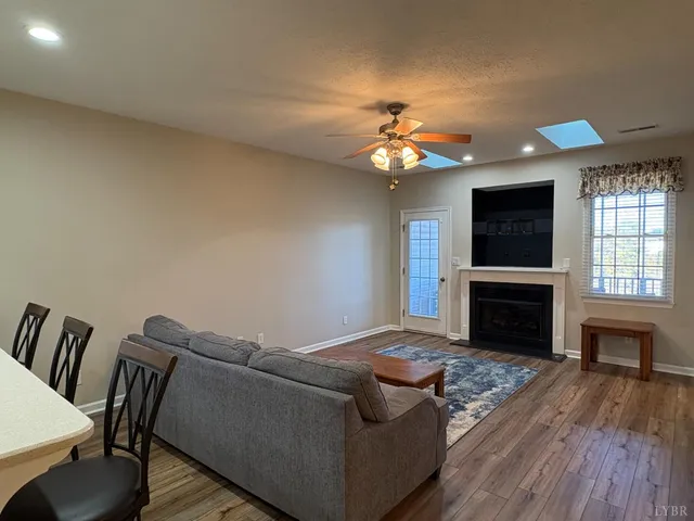 a living room with furniture fireplace and flat screen tv