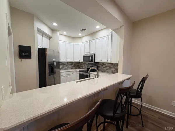 a kitchen with stainless steel appliances a stove a microwave and a sink