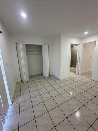 a view of an empty room and wooden floor