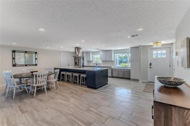 a kitchen with stainless steel appliances granite countertop a sink and a stove