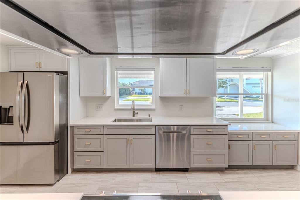 3409 Gulf Winds Circle Hernando Beach, FL 34607 - Photo 19 of 84 a kitchen with a sink a window and stainless steel appliances
