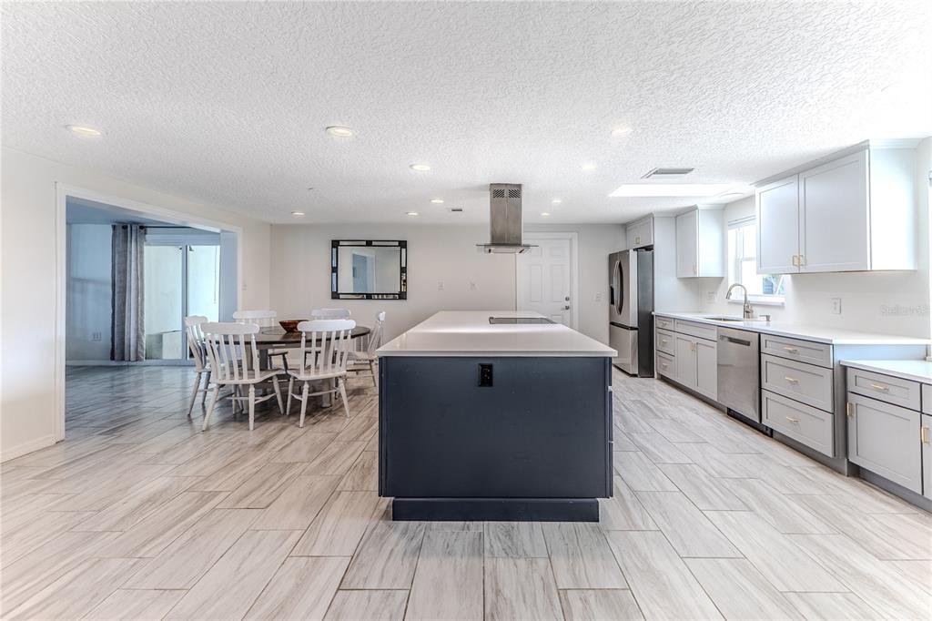 3409 Gulf Winds Circle Hernando Beach, FL 34607 - Photo 21 of 84 a kitchen with stainless steel appliances a sink a stove a refrigerator cabinets and wooden floor