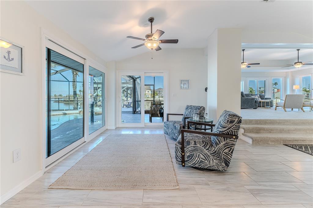 3409 Gulf Winds Circle Hernando Beach, FL 34607 - Photo 25 of 84 a living room with furniture and a floor to ceiling window