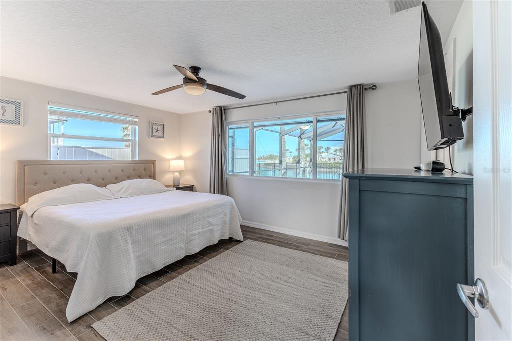 3409 Gulf Winds Circle Hernando Beach, FL 34607 - Photo 35 of 84 a bedroom with a bed and a chandelier