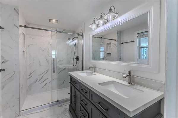 an aerial view of a house with a garden and lake view