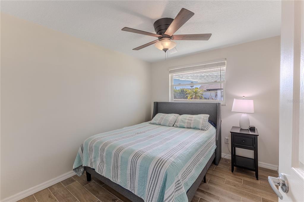 3409 Gulf Winds Circle Hernando Beach, FL 34607 - Photo 44 of 84 a bedroom with a bed and a ceiling fan