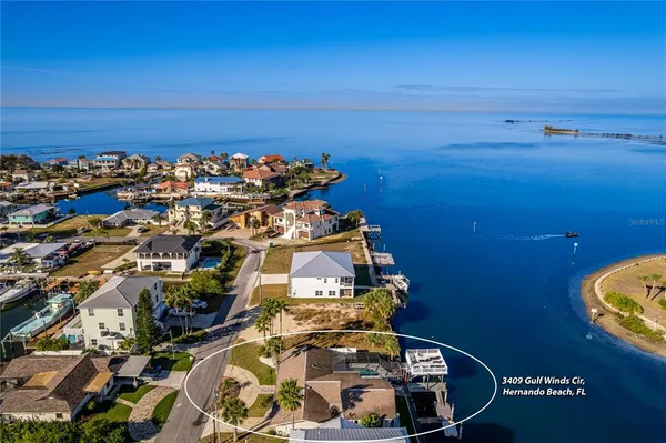 an aerial view of a house with garden space and street view