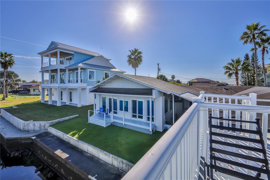 3409 Gulf Winds Circle Hernando Beach, FL 34607 - Photo 65 of 84 a view of a house with a deck and a yard
