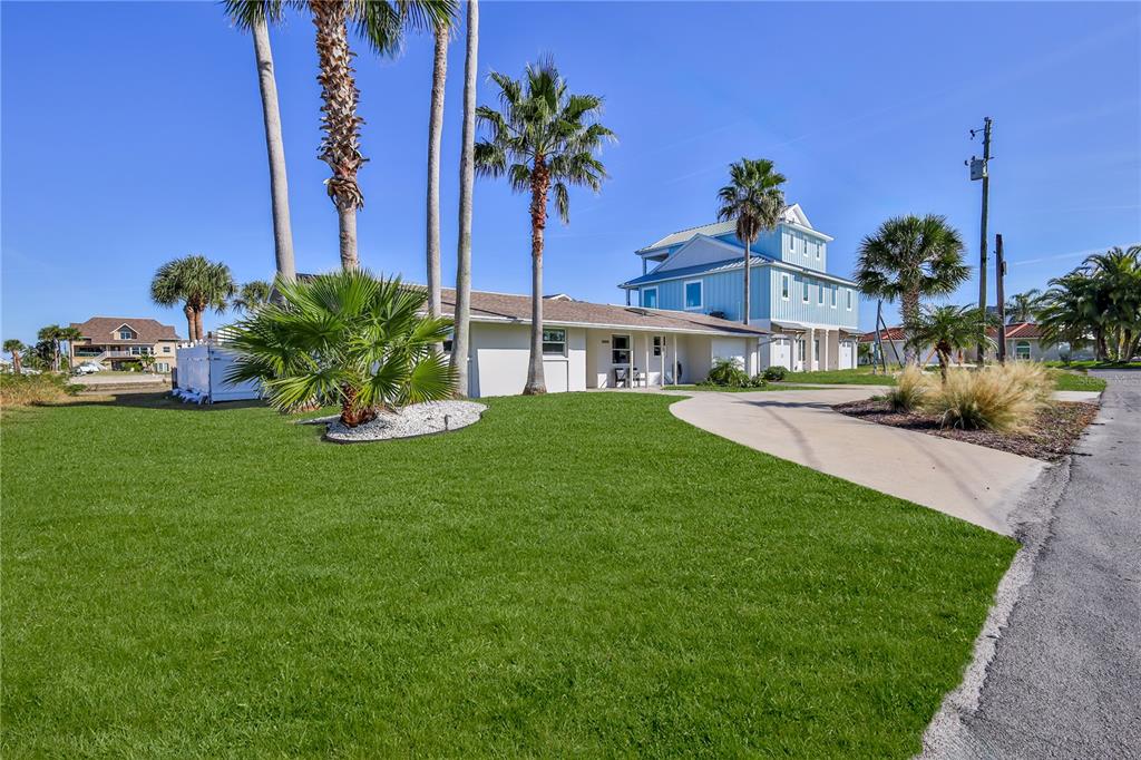 3409 Gulf Winds Circle Hernando Beach, FL 34607 - Photo 7 of 84 a view of a house with a yard and potted plants