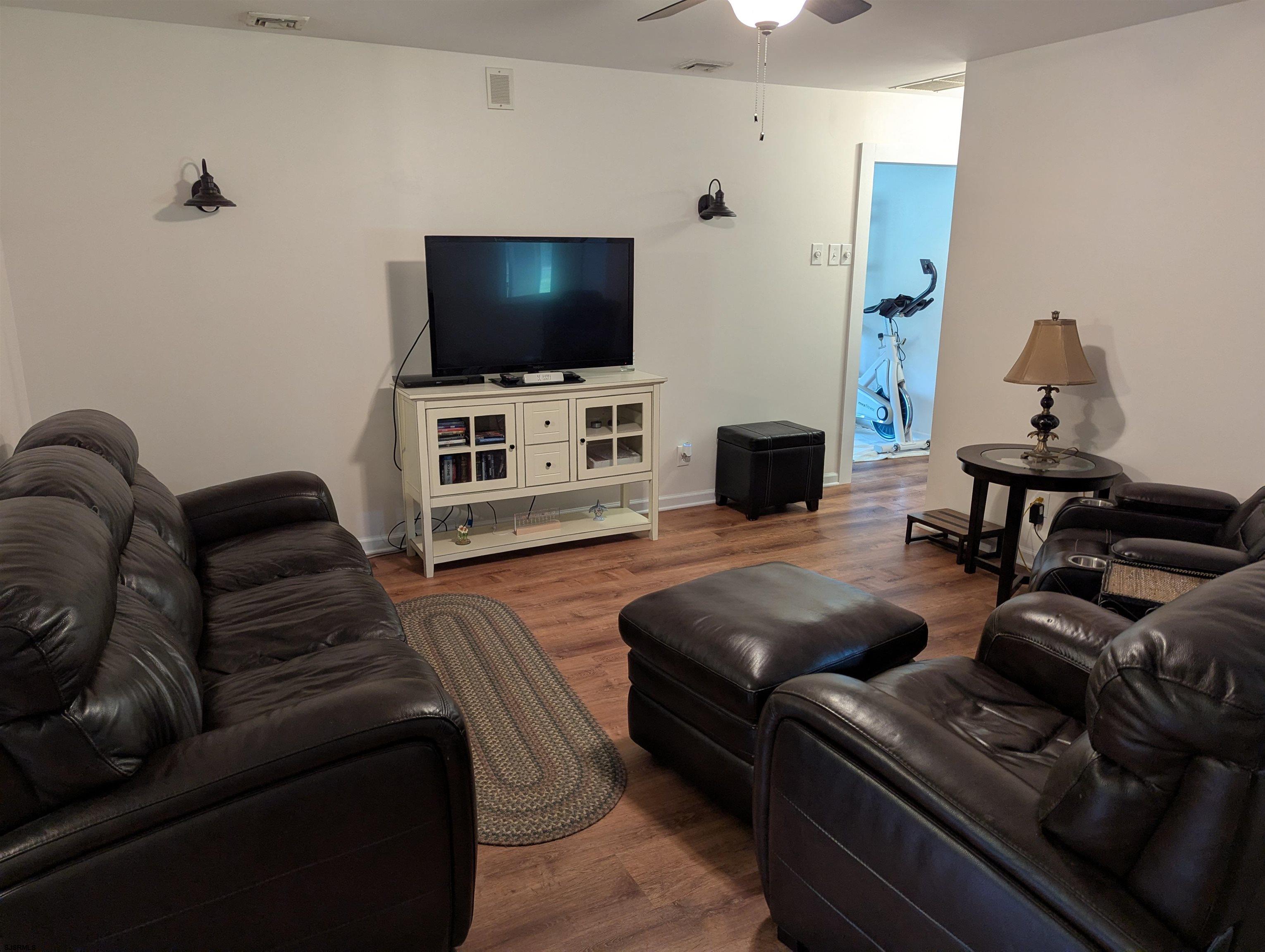 71 Perry Road Woodbine, NJ 08270 - Photo 11 of 32 a living room with furniture and a flat screen tv