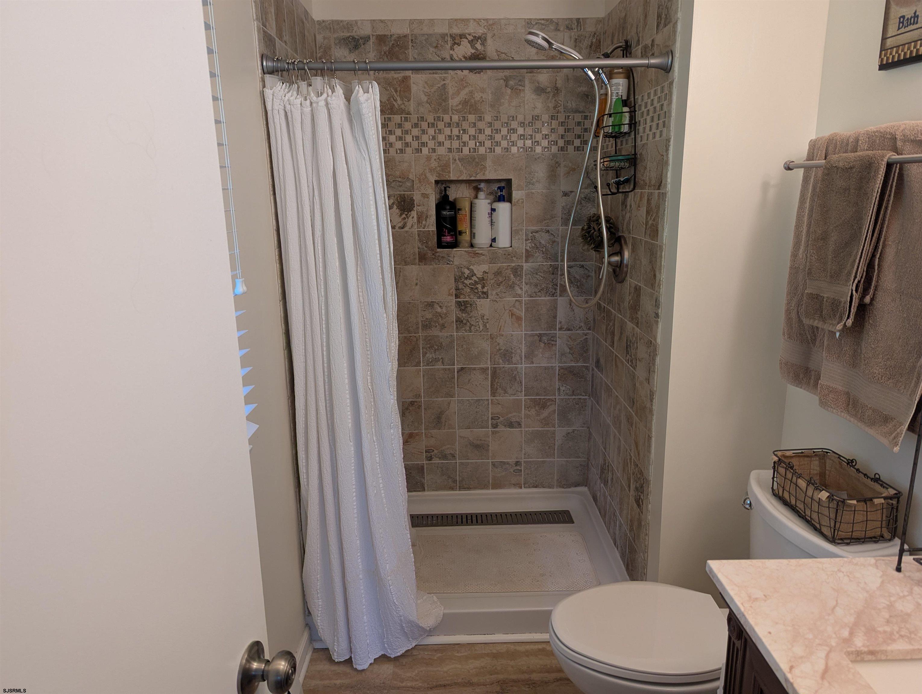 71 Perry Road Woodbine, NJ 08270 - Photo 15 of 32 a bathroom with a shower a toilet and a sink