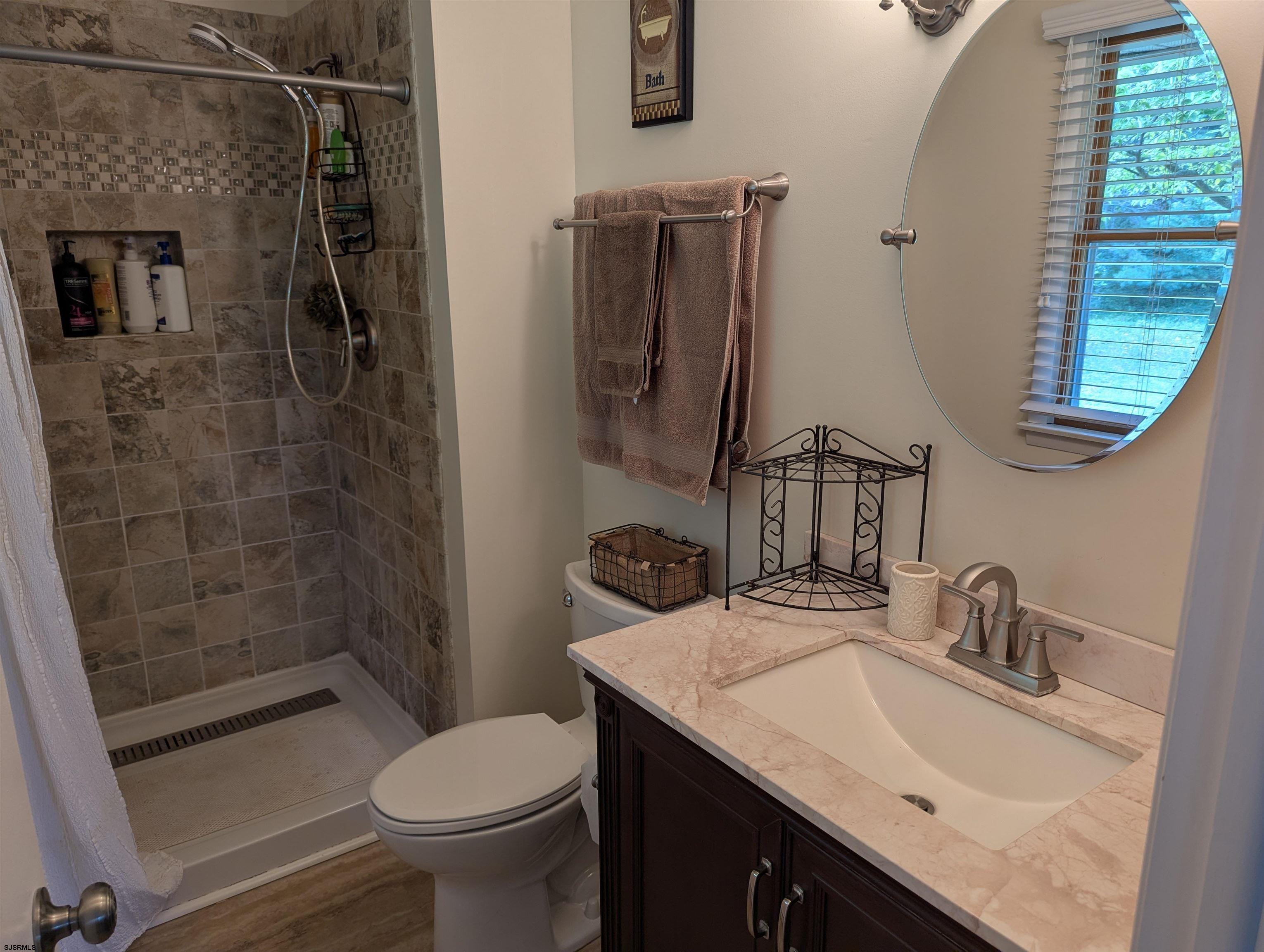 71 Perry Road Woodbine, NJ 08270 - Photo 16 of 32 a bathroom with a sink toilet and shower
