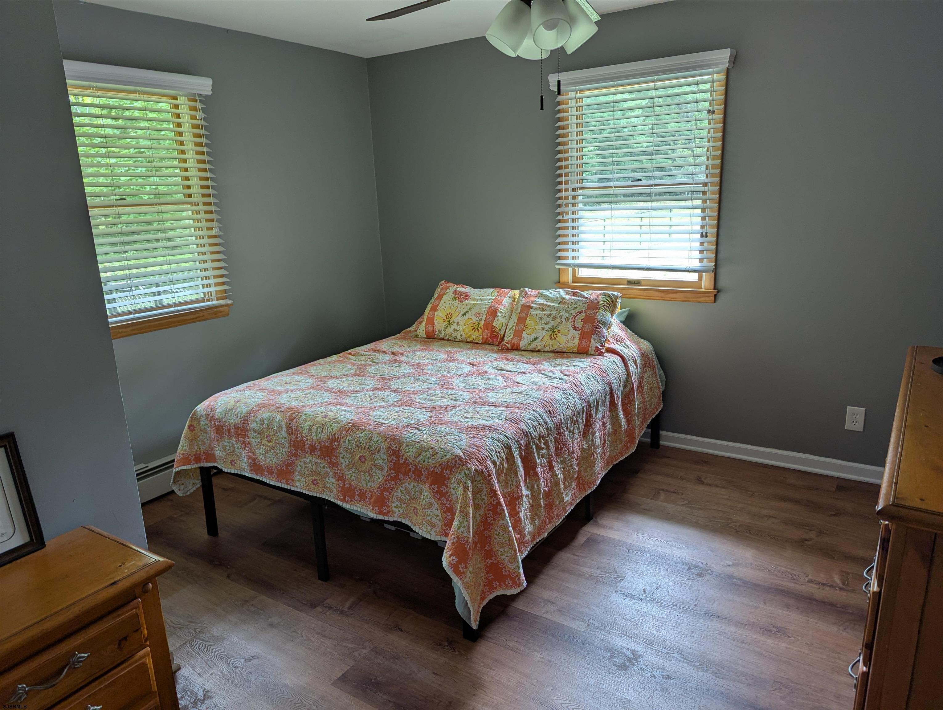 71 Perry Road Woodbine, NJ 08270 - Photo 17 of 32 a bedroom with a bed wooden floor and window