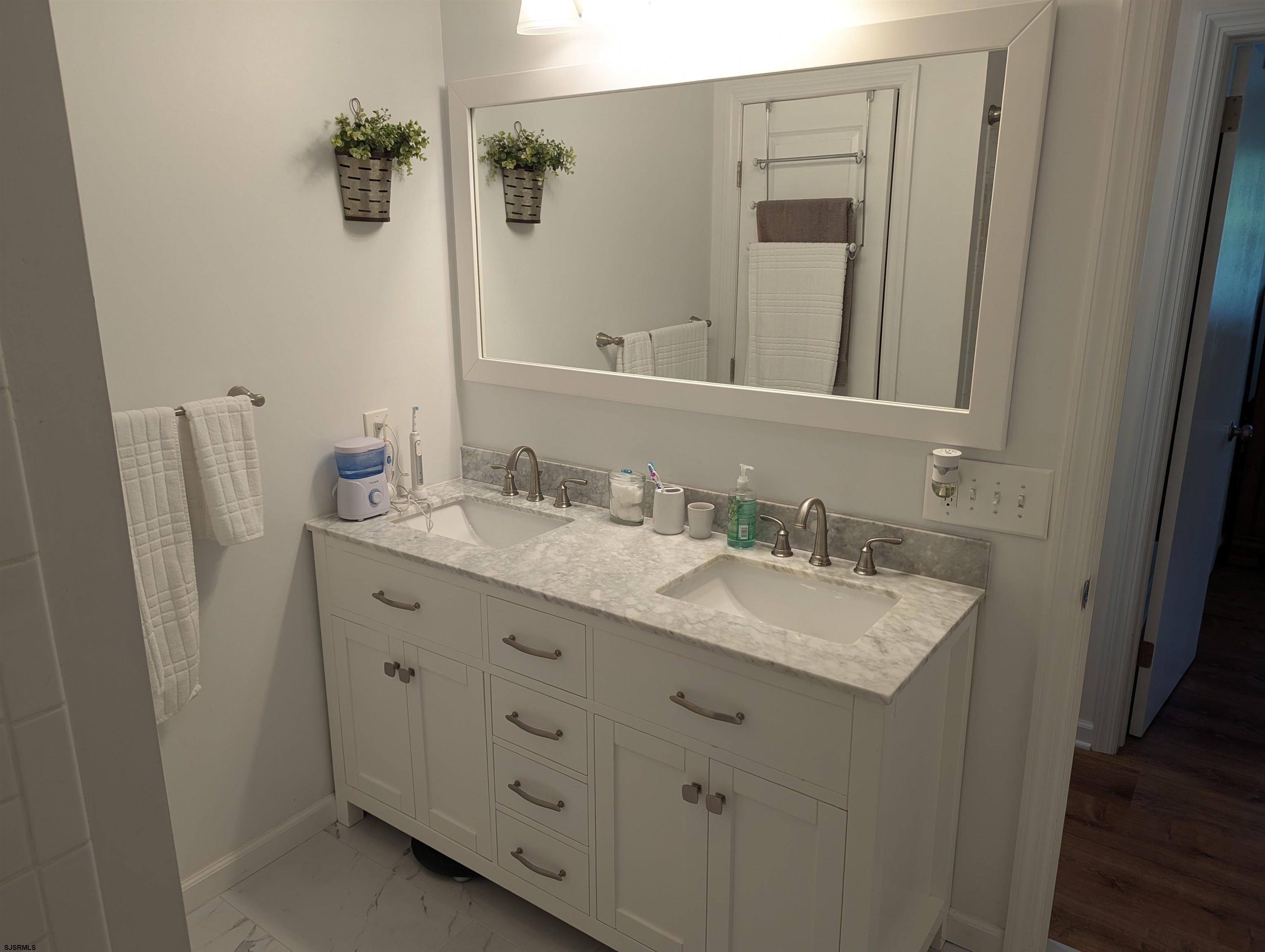 71 Perry Road Woodbine, NJ 08270 - Photo 19 of 32 a bathroom with a granite countertop sink and a mirror