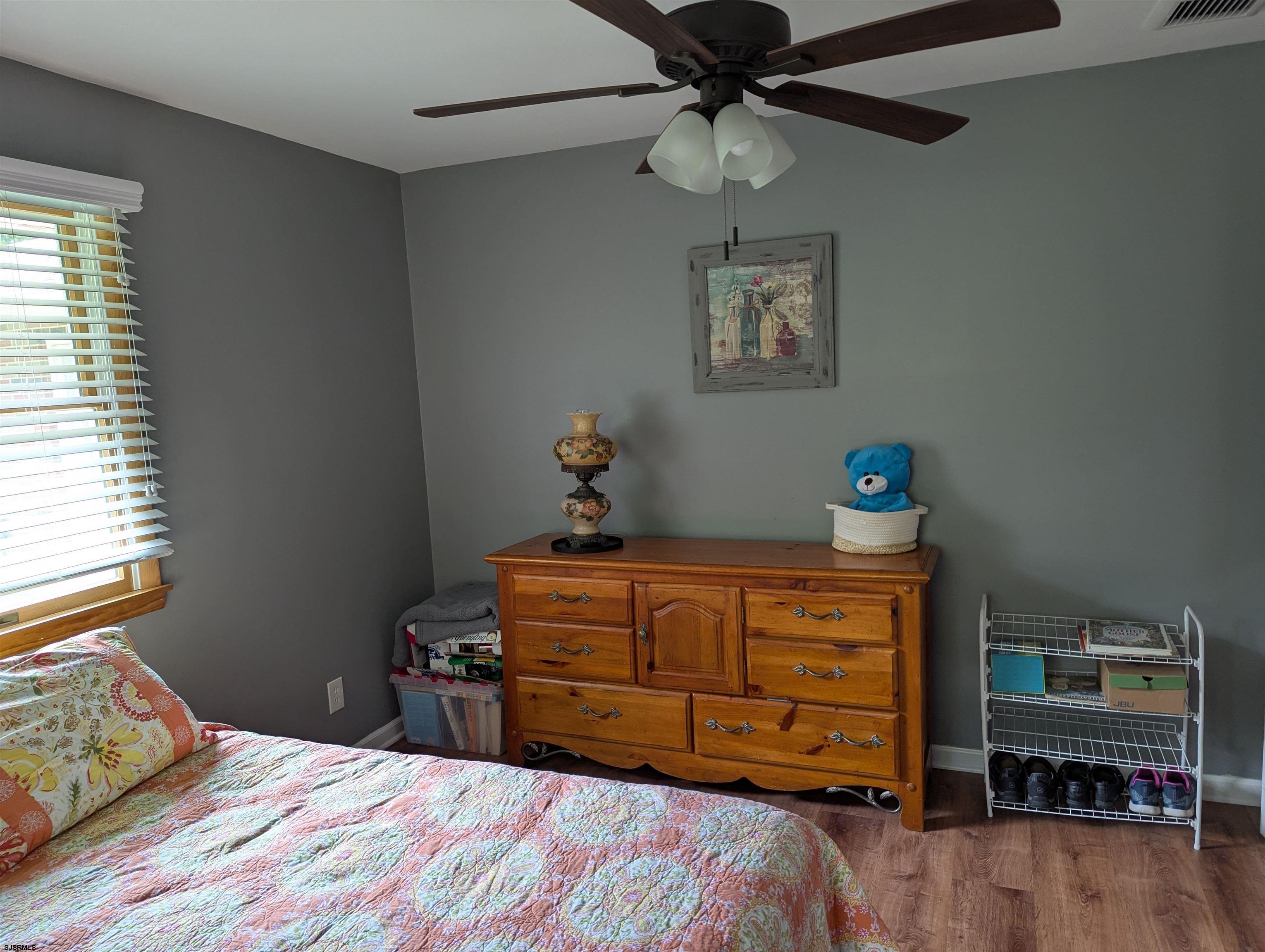 71 Perry Road Woodbine, NJ 08270 - Photo 22 of 32 a bedroom with a bed and wooden floor