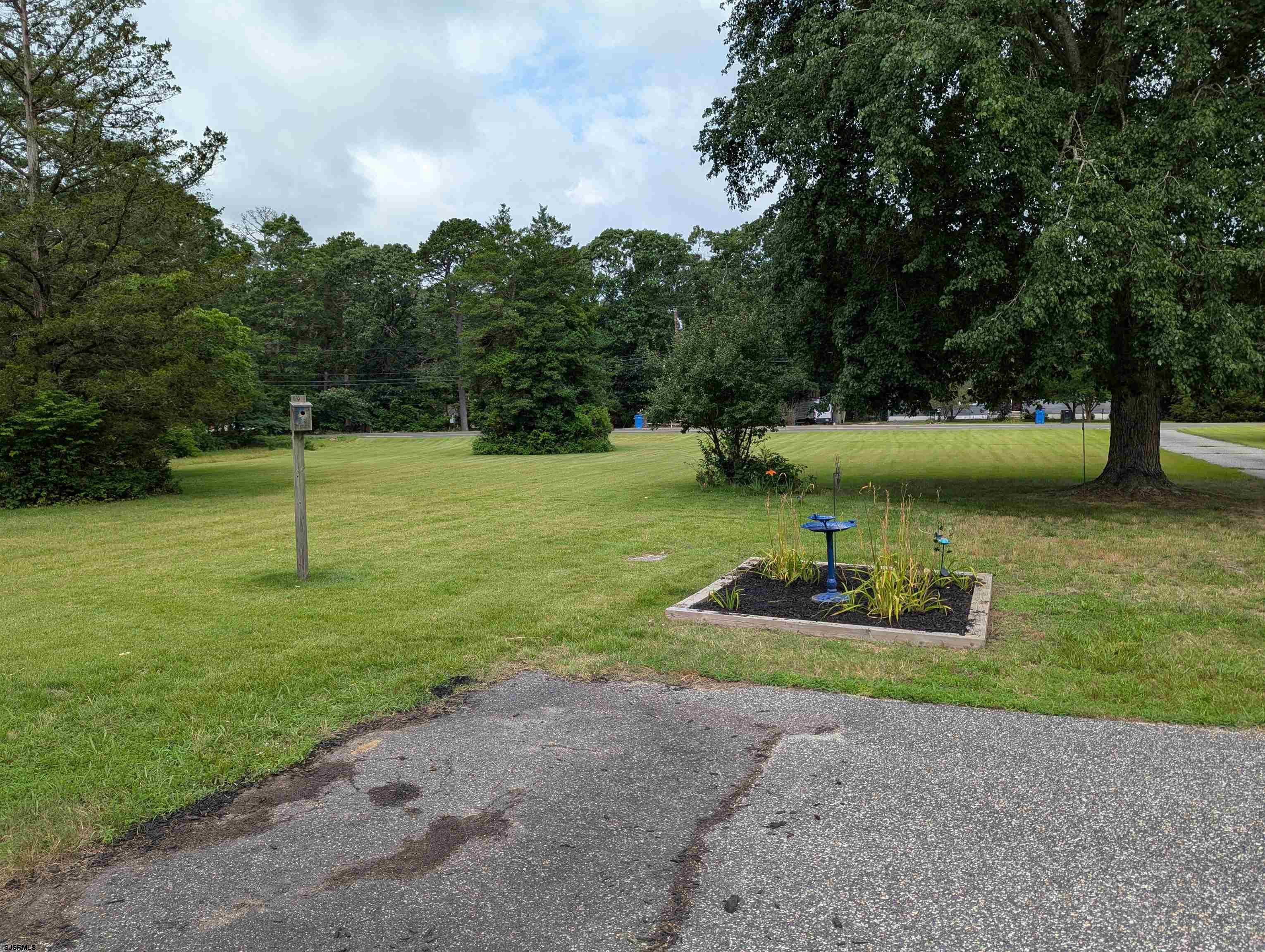 71 Perry Road Woodbine, NJ 08270 - Photo 27 of 32 a backyard of a house with plants and outdoor seating