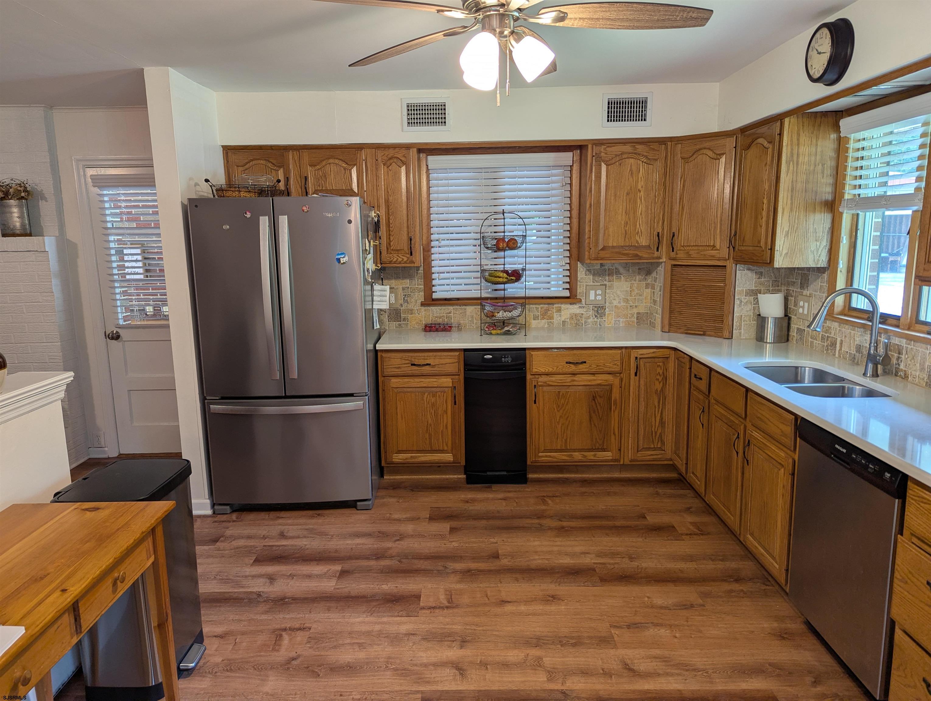 71 Perry Road Woodbine, NJ 08270 - Photo 4 of 32 a kitchen with stainless steel appliances granite countertop a refrigerator a sink dishwasher a stove with wooden cabinets and floor
