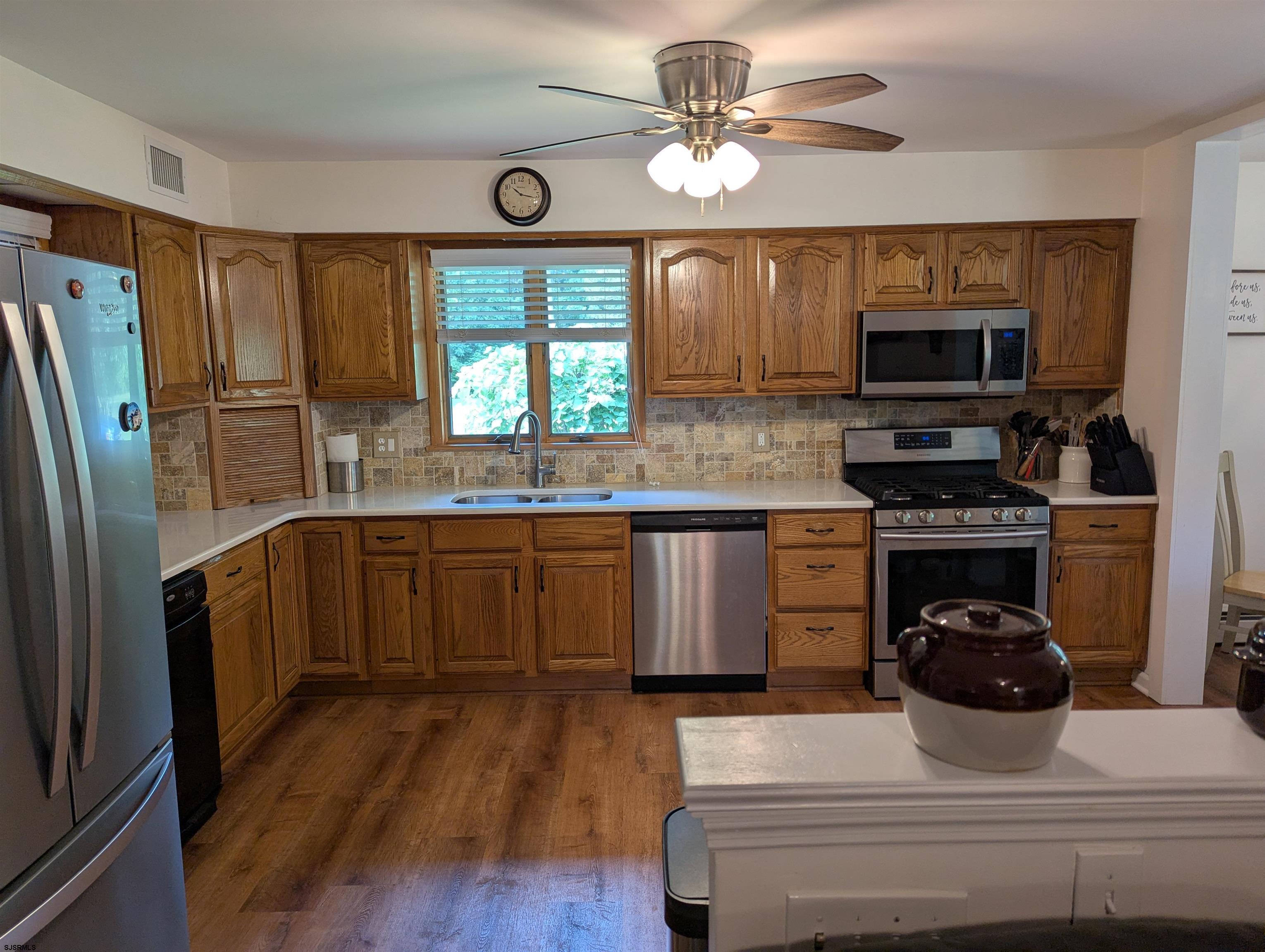 71 Perry Road Woodbine, NJ 08270 - Photo 6 of 32 a kitchen with a stove a sink and a refrigerator
