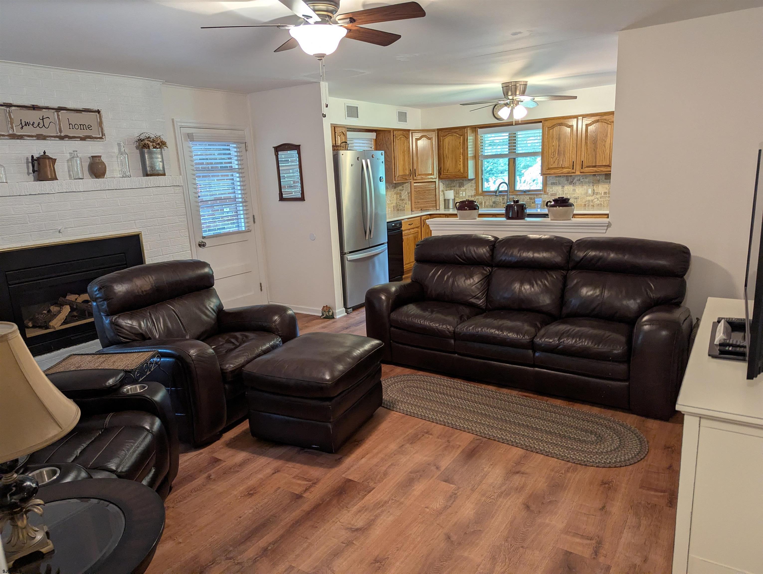 71 Perry Road Woodbine, NJ 08270 - Photo 10 of 32 a living room with furniture and a fireplace