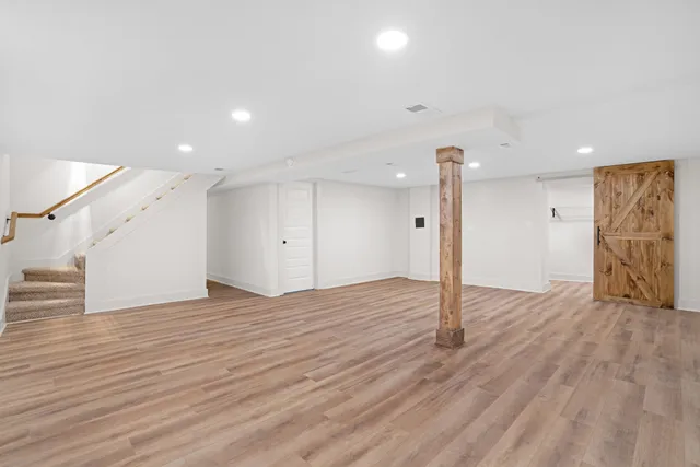 a view of empty room with wooden floor