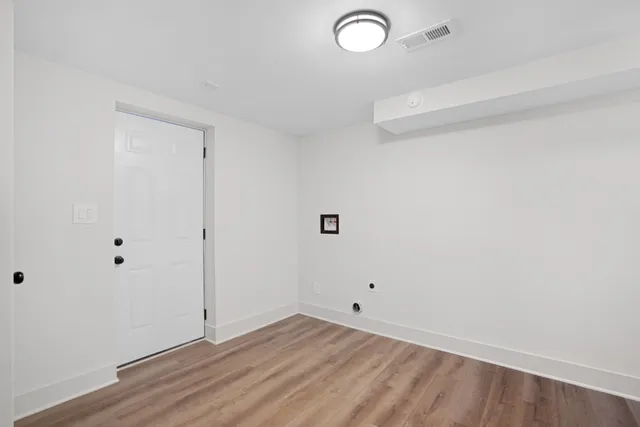 a view of a room with cabinets and empty racks