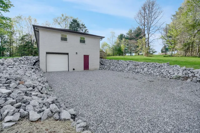 a white house that has a tree in front of it