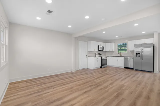 a view of a kitchen with a sink cabinets and stainless steel appliances