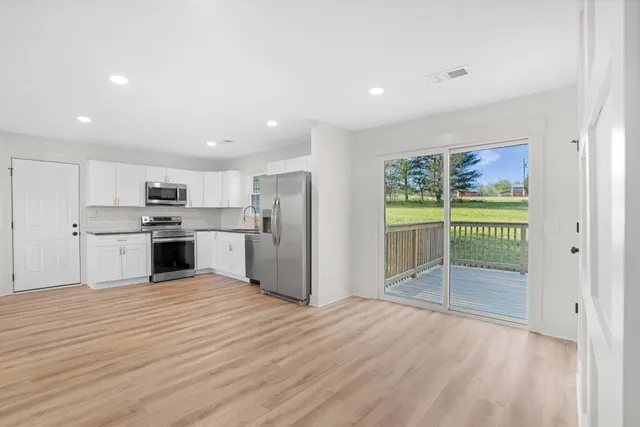 a view of kitchen with wooden floor