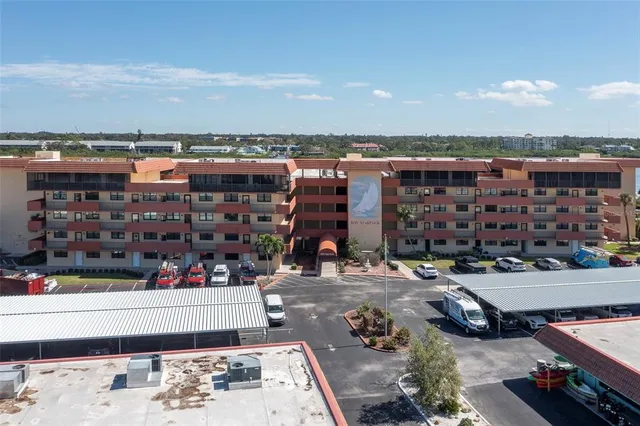 a front view of a building with plants