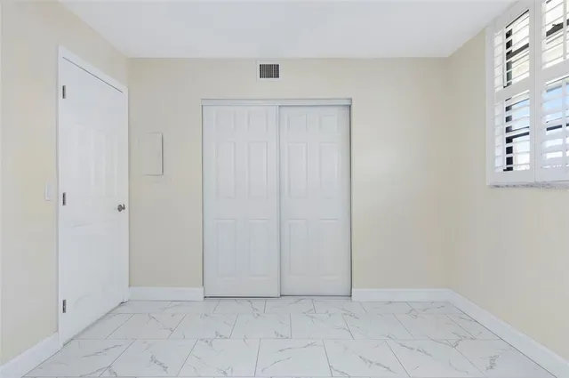 a view of a balcony with two chairs and a table