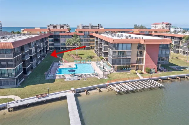 a front view of a house with a yard and outdoor seating