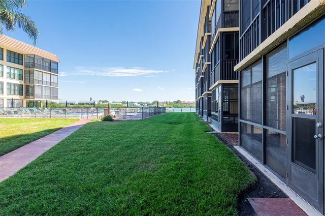 a view of swimming pool with outdoor seating and lake