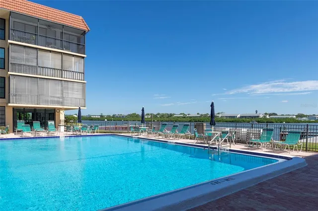 a vase of flowers sitting on a table with chairs